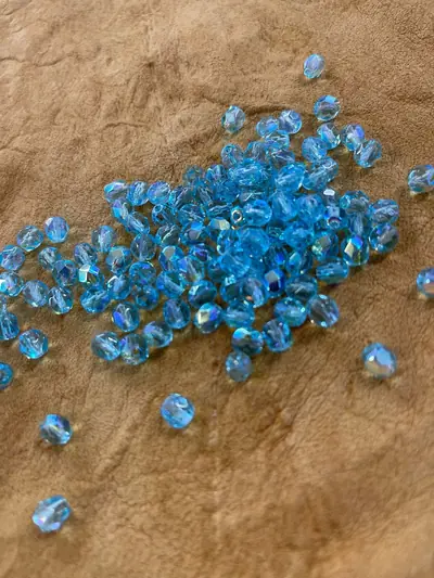 6MM GLASS FACETED 562 AQUA AB