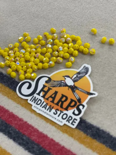 6MM GLASS FACETED OPAQUE YELLOW AB